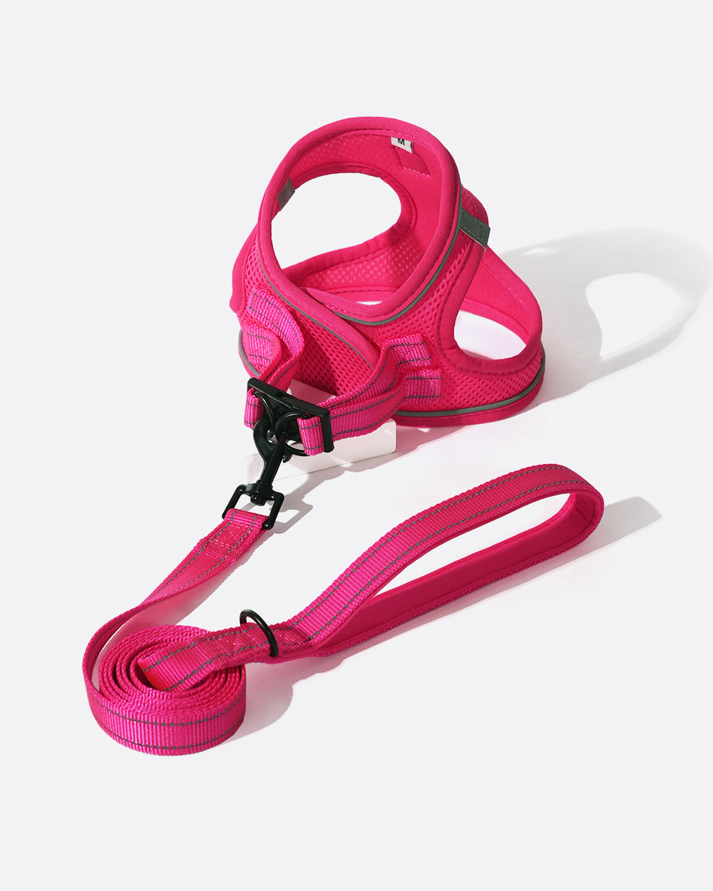 Take the hassle out of daily walks with your dog with this easy-to-use mesh harness featuring a swivel buckle and velcro strap, paired with a matching leash that has a 360 rotating clasp and reflective stitching for added safety.